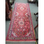 MIDDLE EASTERN RUG, hand knotted rug decorated medallions on a red ground within 3 main borders