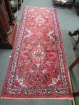 MIDDLE EASTERN RUG, hand knotted rug decorated medallions on a red ground within 3 main borders