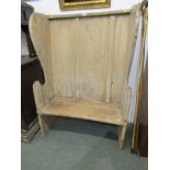 ANTIQUE PINE NARROW SETTLE, sloped back with shaped arm supports, 87cm width