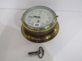 MARITIME, a brass cylindrical case bulk head clock by Mercer with 2 keys, 20cm diameter
