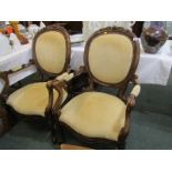 CONTINENTAL DESIGN, pair of floral crested carved walnut open armchairs with scroll arm support