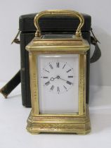 MINIATURE BRASS CARRIAGE CLOCK with attractive foliate engraved casing and antique travel case,