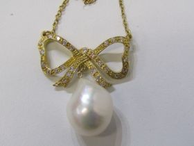 PEARL PENDANT, 18ct yellow gold bow form pendant inset diamonds with large pearl drop on finelink