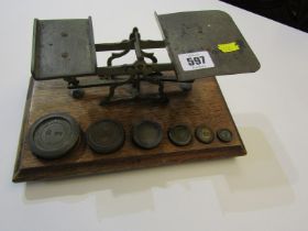 ANTIQUE POSTAL SCALES, oak based balance scales with 5 graduated weights