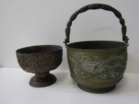 EASTERN METALWARE, a Chinese brass swing handled temple pot decorated with fabulous dragons;