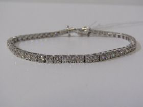 IMPRESSIVE DIAMOND LINE BRACELET, 18ct white gold bracelet, set 52 well matched round brilliant