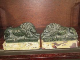 EUROPEAN CARVED HARDSTONE SCULPTURES, pair of veined marble base lion paperweights, 13cm length