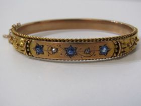 SAPPHIRE, DIAMOND & GOLD BANGLE, 9ct yellow gold hinged bangle, set 3 cornflower sapphires,