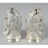 A PAIR OF SILVER PLATED BOAR'S HEAD SALT AND PEPPERS, 6 cm.