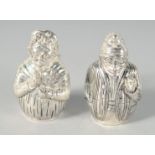 A PAIR OF SILVER PLATED PUNCH AND JUDY SALT AND PEPPERS, 5 cm.