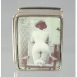A SILVER AND ENAMEL NUDE PILL BOX, 3 cm.