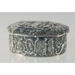 AN OVAL SILVER CHERUB EMBOSSED PILL BOX, 5 cm long