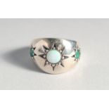 A SILVER OPAL AND EMERALD GYPSY RING.