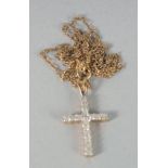 A 9ct. GOLD DIAMOND CROSS AND CHAIN.