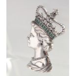 A SILVER QUEEN ELIZABETH EMERALD CROWN BROOCH.