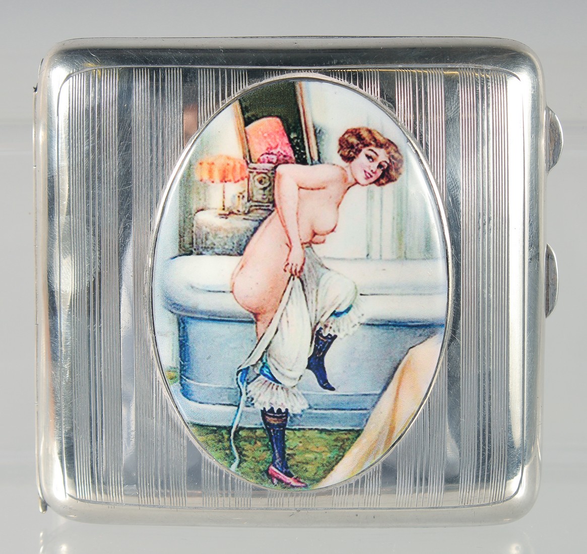 A GEORGE V ENGINE TURNED SILVER CIGARETTE CASE, with an oval enamel of a nude. Birmingham, 1919.