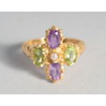 A SILVER GOLD PLATED PERIDOT, AMETHYST, AND PEARL SUFFRAGETTE STYLE RING.