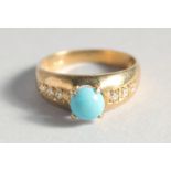 A SILVER GOLD PLATED TURQUOISE RING.