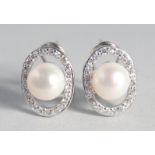 A PAIR OF SILVER AND PEARL EARRINGS.