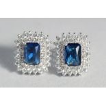 A PAIR OF SILVER FAUX SAPPHIRE EAR STUDS.