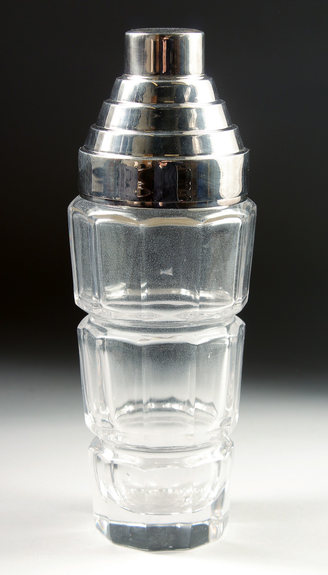 A SILVER PLATED AND GLASS COCKTAIL SHAKER.