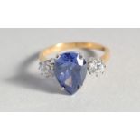 A SILVER GOLD PLATED, PEAR SHAPED, FAUX TANZANITE AND CUBIC ZIRCONIA RING.