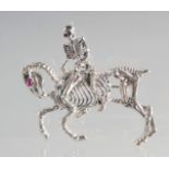 A SILVER ANATOMICAL HORSE AND SKELETON RIDER BROOCH.