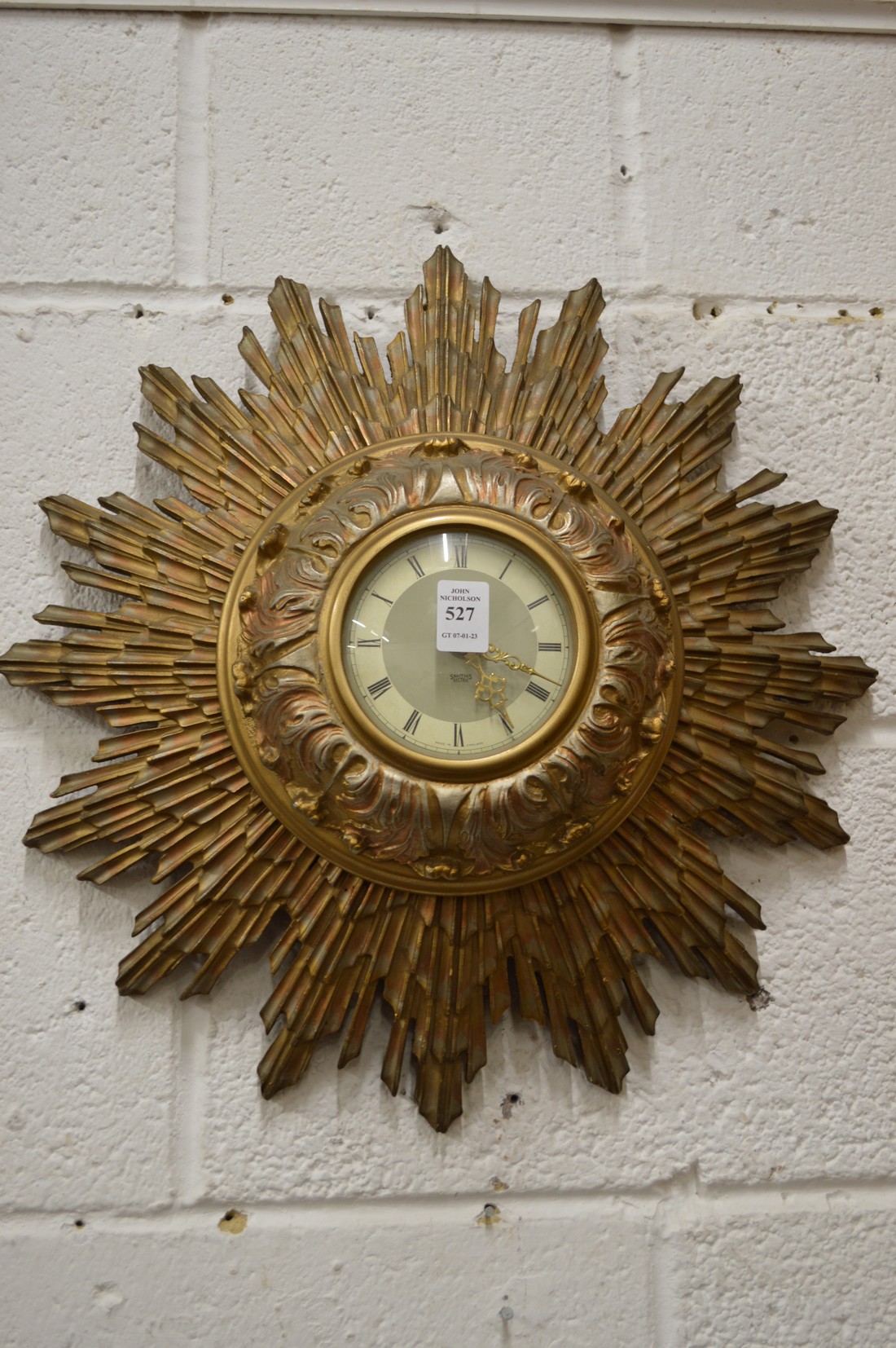 A Smiths electric sunburst wall clock.