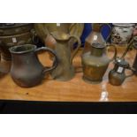 Four copper and brass jugs.