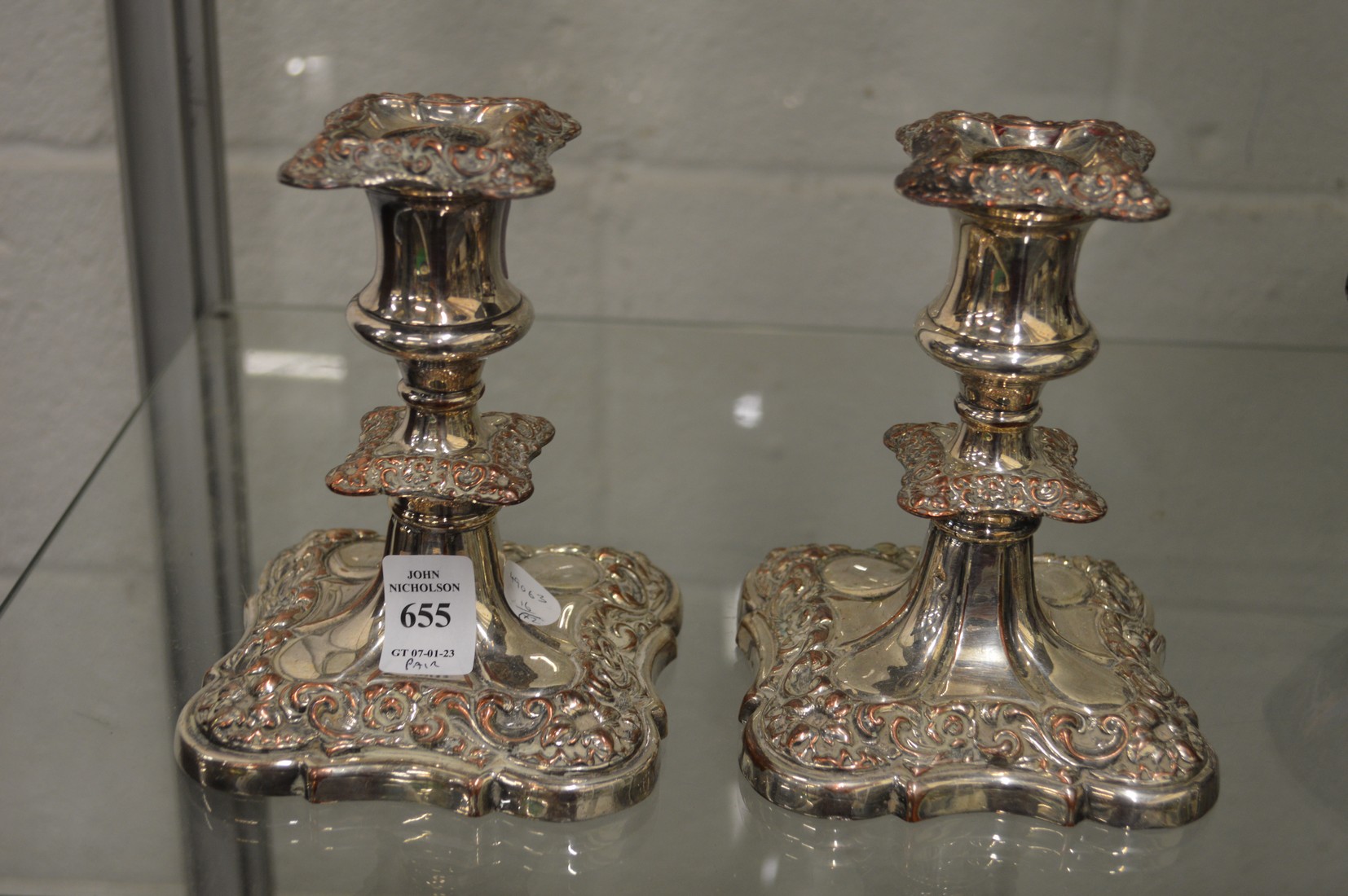 A pair of plated candlesticks.