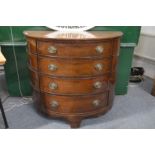 A George III mahogany demi lune four drawer chest.