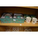 A pair of boxed cups and saucers and a pair of boxed mugs.