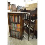 Two small oak bookcases with various books.