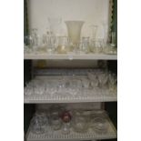 Three shelves of glassware.