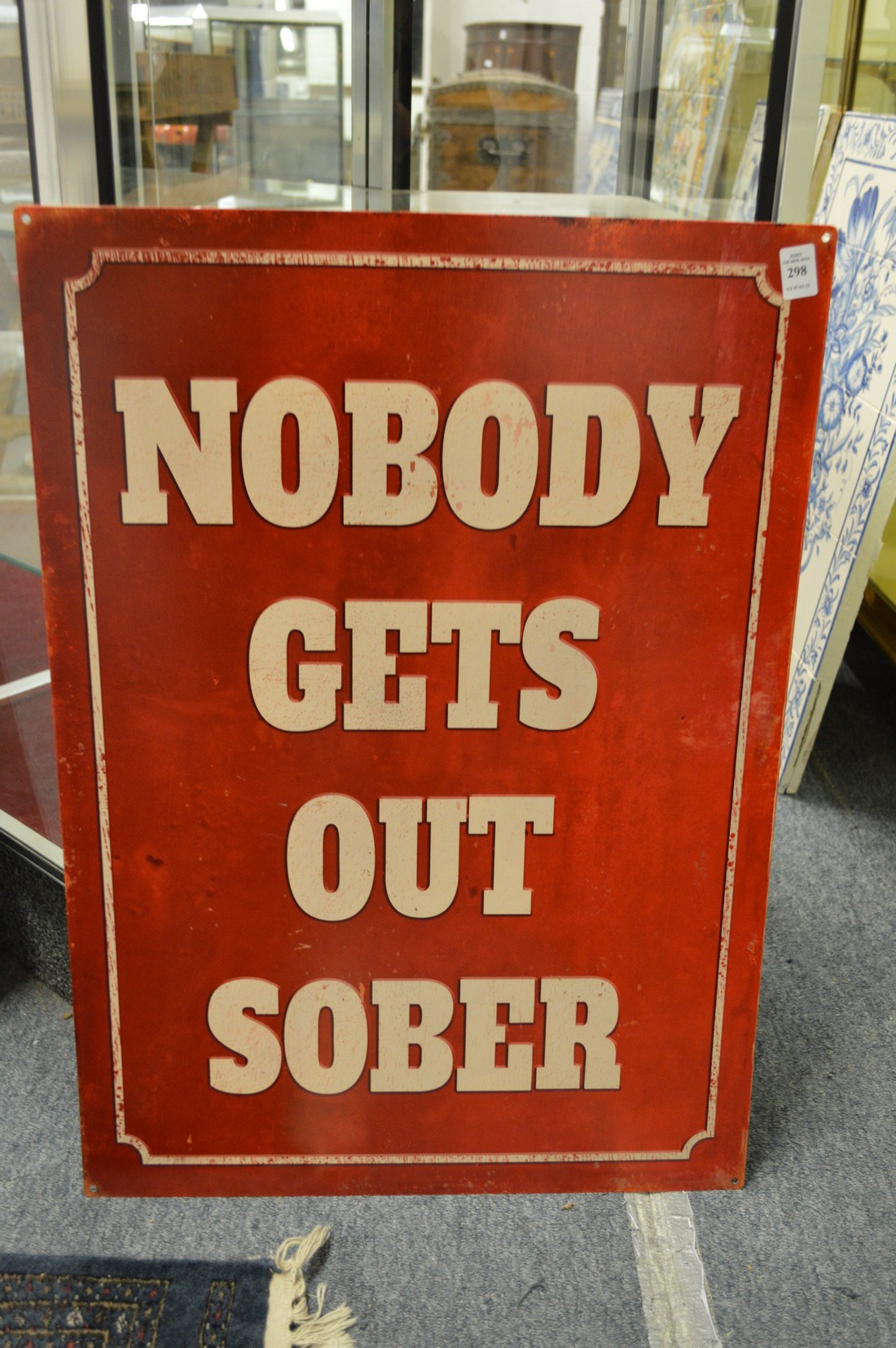 A novelty printed metal sign.