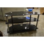 A glass three tier corner TV stand.