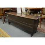 An 18th century oak six plank sword chest or coffer (one leg af).