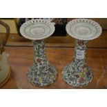 A pair of royal Doulton Persian pattern candlesticks.