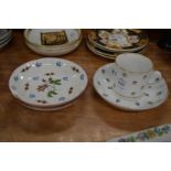 Porcelain coffee cup and saucer and a pair of decorative saucer dishes.