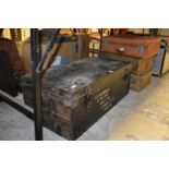 An old metal trunk and three suitcases.