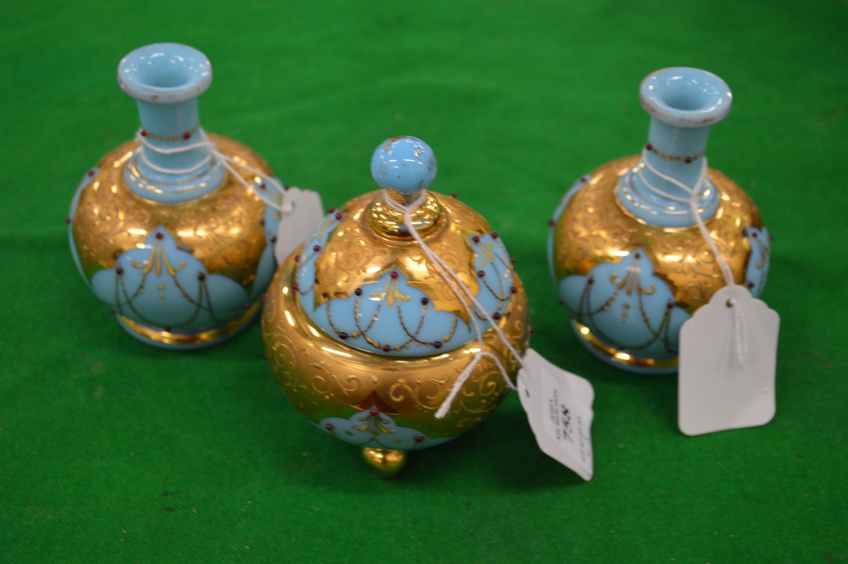 A gilt decorated opaque glass bowl and cover and pair of matching vases.