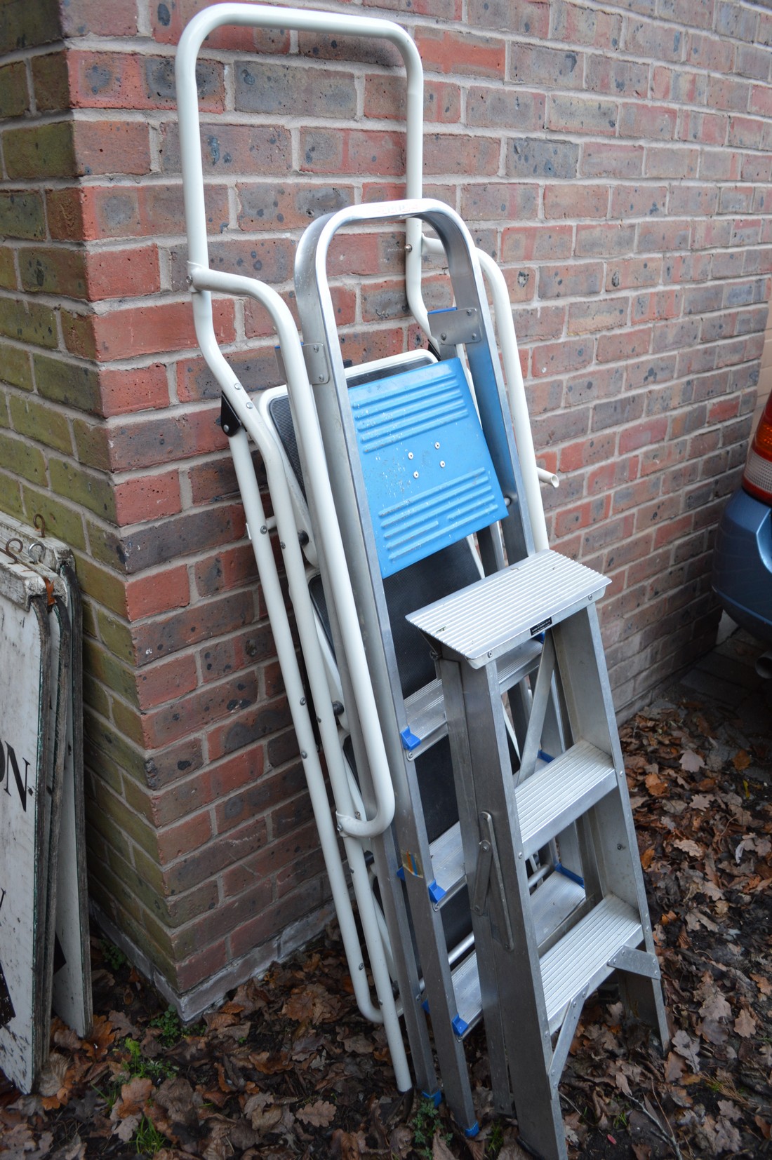 Three metal step ladders.