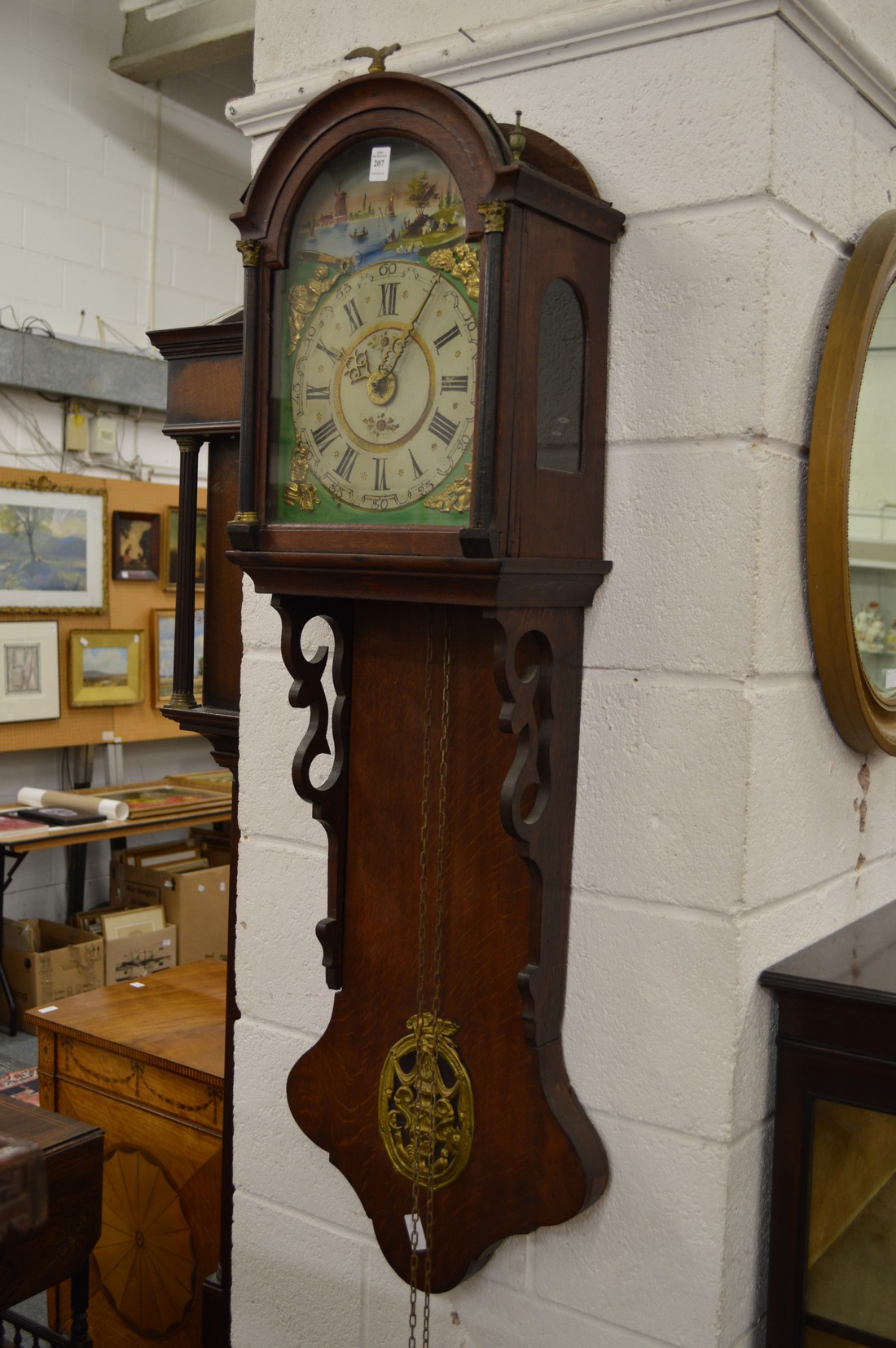 A Continental oak wall clock with painted arched dial.