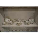 A collection of eight Herend porcelain cups and saucers painted with birds and butterflies.