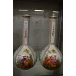 A pair of Dresden porcelain bottle vases painted with panels of figures and flowers (rim damaged and