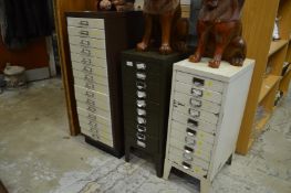 Three metal multi-drawer filing cabinets.