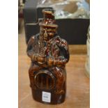 A figural treacle glazed flask.