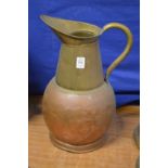 A large copper and brass jug.