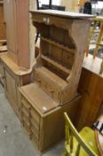 A pine wall shelf with drawers and a small pine four drawer chest.