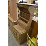 A pine wall shelf with drawers and a small pine four drawer chest.